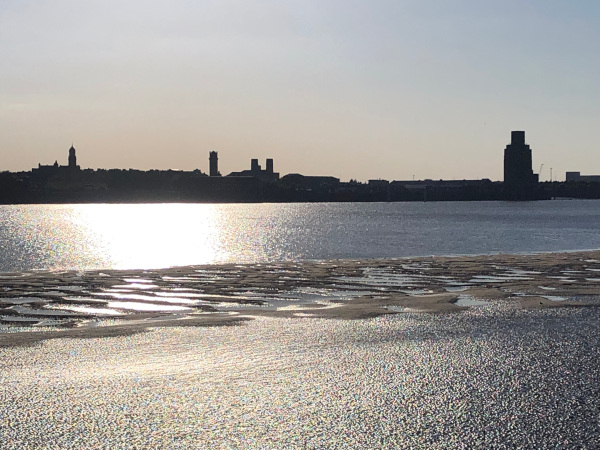 Skyline across the water of Birkenhead at sunset, taken from the Waterfront at Queen's Dock
